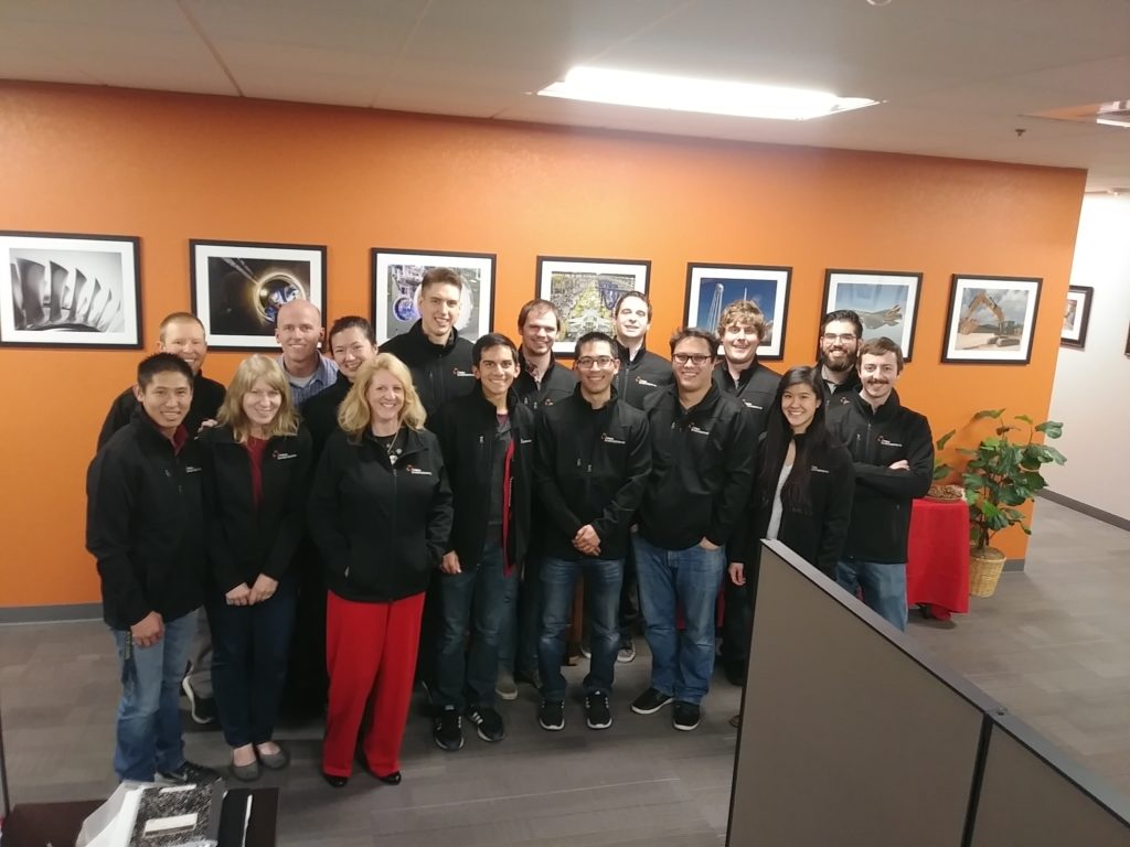 Group photo of Hill Engineering employees wearing their new company jackets.