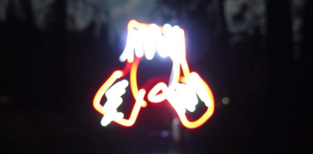 A long exposure photograph of the Hill Engineering logo, slightly out of focus.