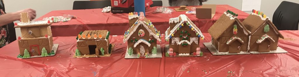 Hill Engineering gingerbread houses. Six gingerbread houses in a row, made by different employees.